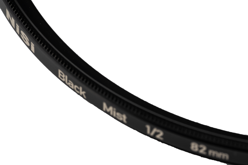 Close-up of the NiSi filter Black Mist 1/2 52mm diffusion filter, partially visible against a white background.