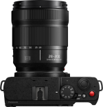Top view of Panasonic Lumix S9 Jet Black digital camera with 28-200mm f/4-7.1 Macro lens with controls, power switch, shutter button and camera shoe mount.