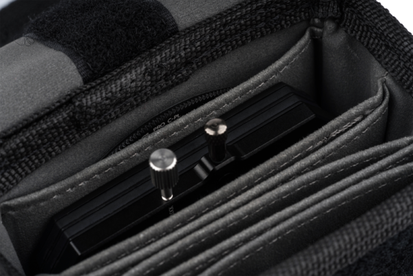 The close-up of the NiSi Pouch for M75 Holder and Filters shows the camera filter holder with metal knobs, neatly stored in one of its padded compartments.