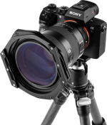 A Sony Alpha camera with a large lens and a 100 mm NiSi Switch filter holder is mounted on a tripod, viewed from the front against a plain background.