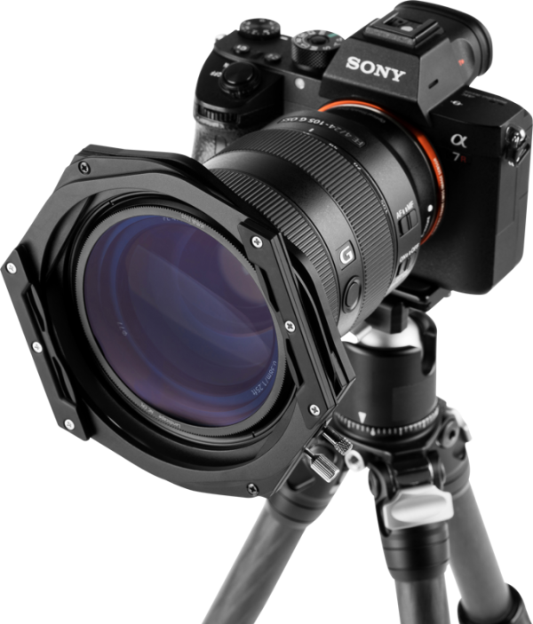 A Sony Alpha camera with a large lens and a 100 mm NiSi Switch filter holder is mounted on a tripod, viewed from the front against a plain background.