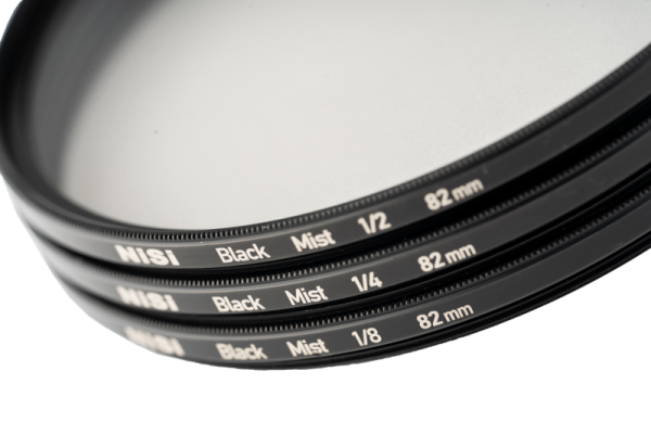 The close-up shows the NiSi Filter Black Mist 1/2 52mm diffusion filter stacked with other Black Mist filters against a white background.