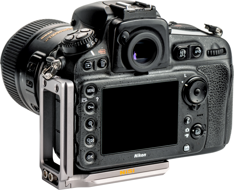 A black Nikon DSLR camera with a wide-angle lens and blank LCD screen on the back is visible from behind, with a NiSi Universal Adjustable L-Plate NLP-C metal mount attached to the left side and bottom.