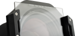Close-up of a camera lens with a NiSi Square Black Mist 1/4 100x100mm filter mounted in front of it, held in a filter holder with metal screws on each side.