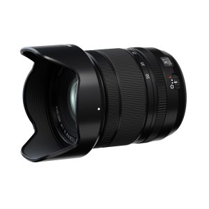 Black Fujifilm Fujinon XF 16-50mm f/2.8-4.8 R LM WR zoom lens with lens hood attached, in white background.