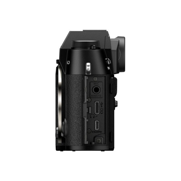 Side view of the Fujifilm X-T50 system camera, black, showing HDMI, microphone and remote control ports, with the lens mount visible on the left side of the camera body.