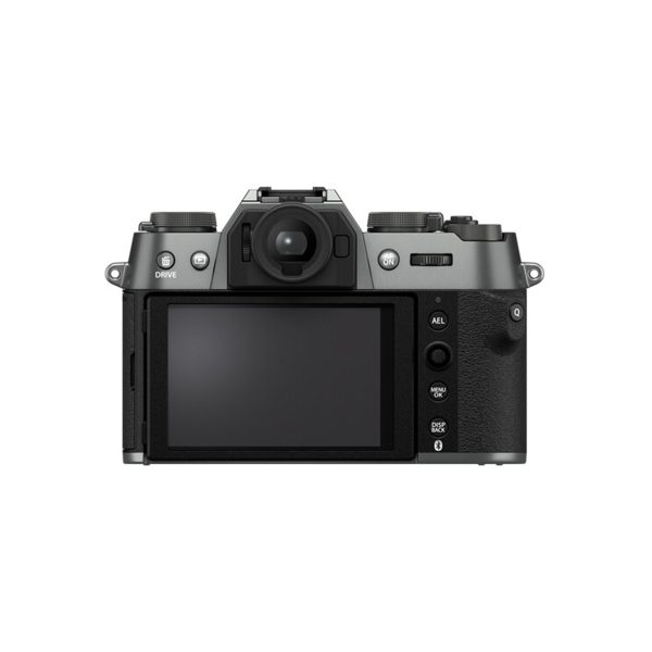 The Fujifilm X-T50 system camera, in grey, features an LCD screen, viewfinder and control buttons on the back, on a silver and black body against a white background.