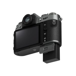 Fujifilm X-T50 system camera, grey, rear view showing LCD screen, control buttons and partially extended battery compartment. The camera has a textured grip and viewfinder.