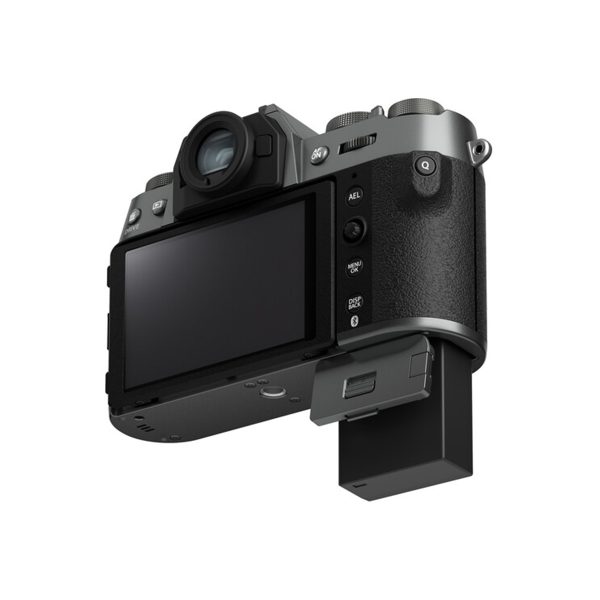 Fujifilm X-T50 system camera, grey, rear view showing LCD screen, control buttons and partially extended battery compartment. The camera has a textured grip and viewfinder.