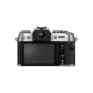 The Fujifilm X-T50 system camera, silver visible from the rear, features a large LCD screen with various control buttons and dials on its silver and black body against a white background.