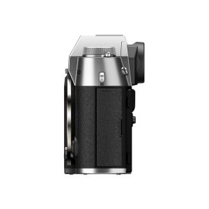 Side view of the Fujifilm X-T50 system camera, silver with textured black grip, visible control buttons and HDMI port against a white background.