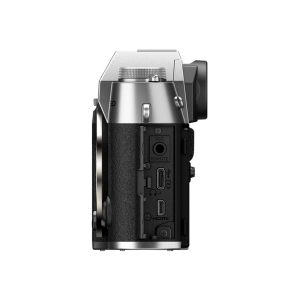 Fujifilm X-T50 system camera, silver, shown from left, revealing MIC, REMOTE, HDMI and USB ports, textured grip and its silver-black body against a white background.