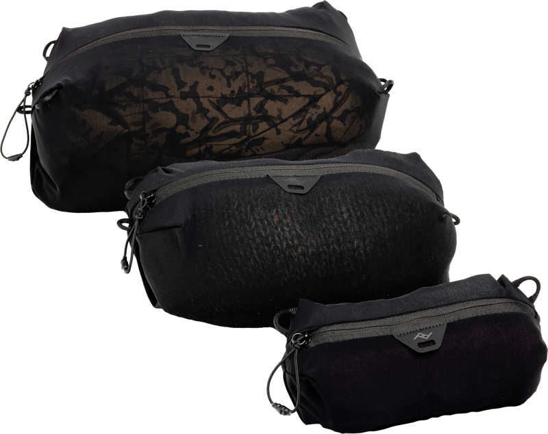 The black Peak Design Ultralight Mesh Packing Cube Bundle XXS-XS-S features three differently sized, patterned zippered pouches, each with side loops for easy attachment or carrying.