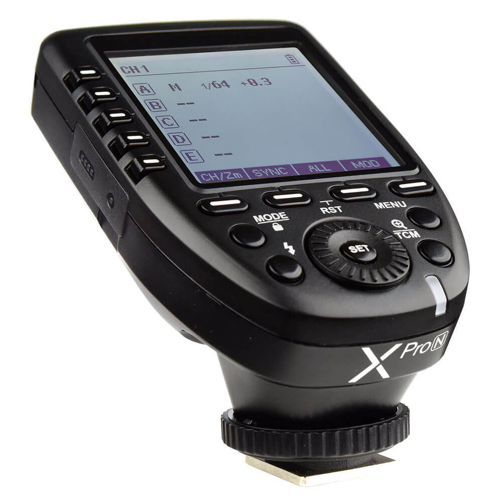 Close-up Godox Location BARDT KIT Canon battery flash kit, a black wireless camera flashgun with multiple buttons and a large LCD display showing flash settings and channels.