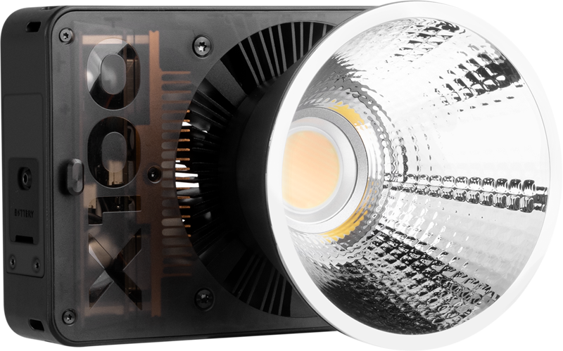 Close-up of the Zhiyun LED Molus X100 COB Light with reflective silver cone, visible heat sinks and detailed internal components visible through the bright side panel.