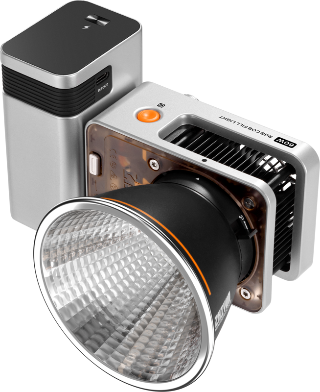 Zhiyun LED Molus X60 RGB Combo Cob Light on kompakti, moderni studiovalo, jossa on suuri heijastin, hopeinen ja musta kotelo, jäähdytysventtiilit, oranssi virtapainike ja jossa on merkinnät "60W" ja "RGB COB PANEL LIGHT".