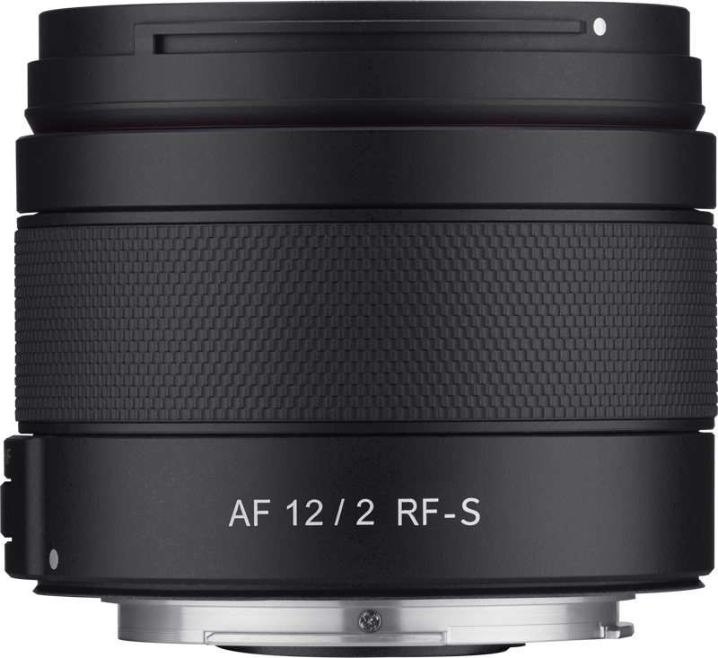 The black Samyang AF 12mm F/2.0, Canon RF-S lens with textured grip is displayed from the side against a plain background, and features the AF 12/2 RF-S label, as well as autofocus and aperture information.