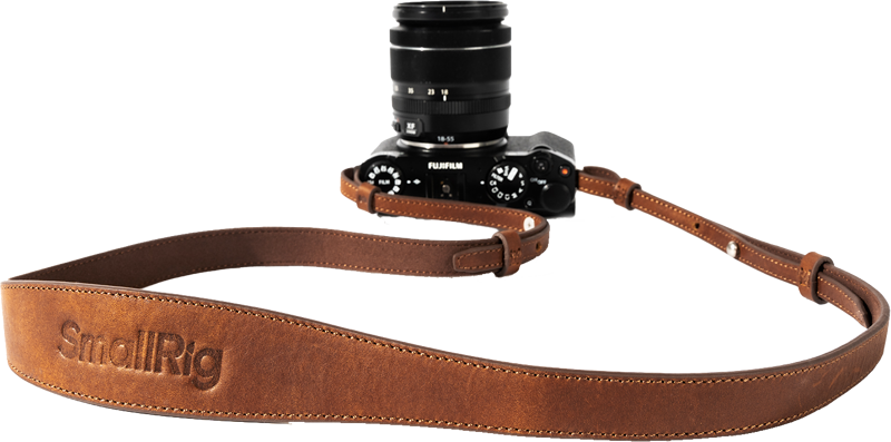 Black Fujifilm camera with SmallRig 5209 Universal Leather Camera Shoulder Strap, brown with light background. "SmallRig" is embossed on the strap.