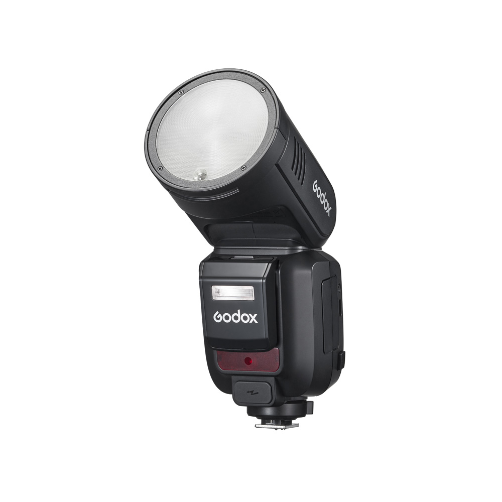 Godox Speedlite V100 flash for Fujifilm cameras, with round head, black stand, digital display and buttons, shown facing upwards on a white background.