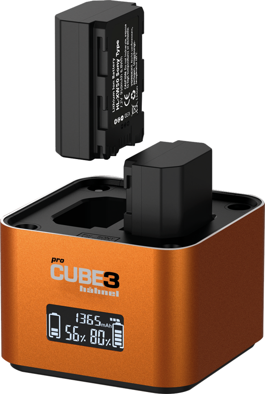 A close-up of the orange Hähnel ProCube 3 Twin Charger Sony charger shows one battery inserted in place, the other inserted above and its illuminated digital display showing charging information.