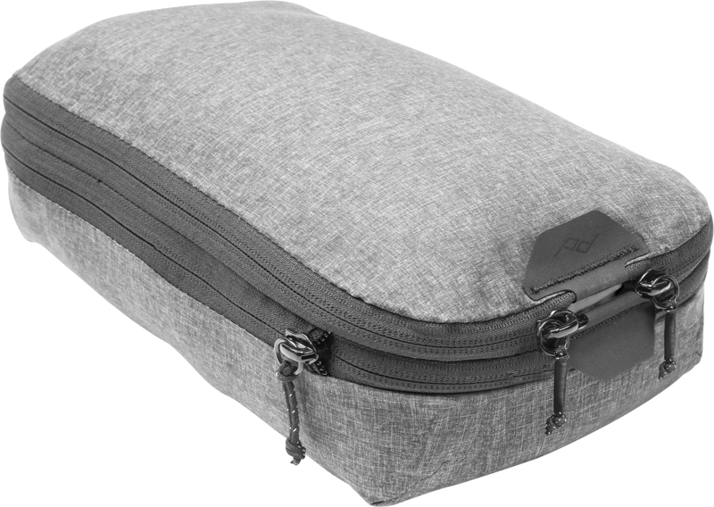 Peak Design Packing Cube // Small // Charcoal is a grey rectangular fabric organizer with two zippers and a small logo flap, designed for efficient organization of luggage.