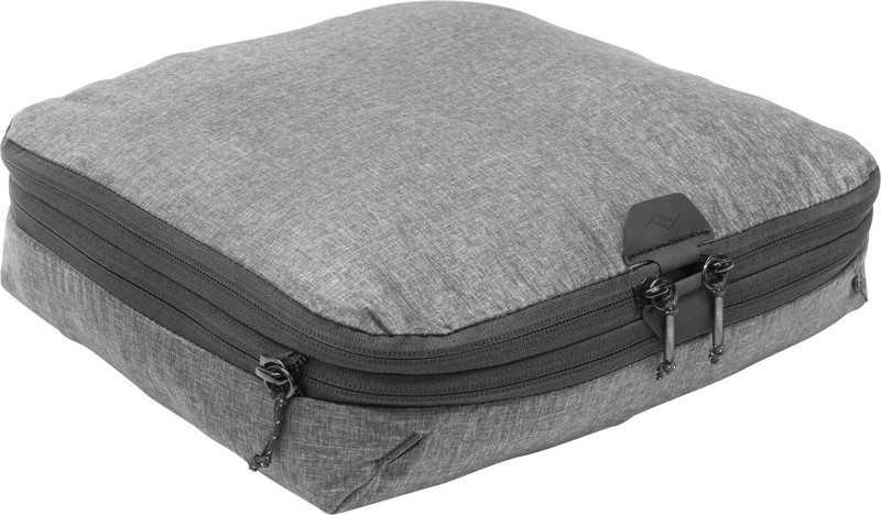 Peak Design Packing Cube // Medium // Charcoal is a grey rectangular packing cube with two black zippers and a fabric texture, with a light background.