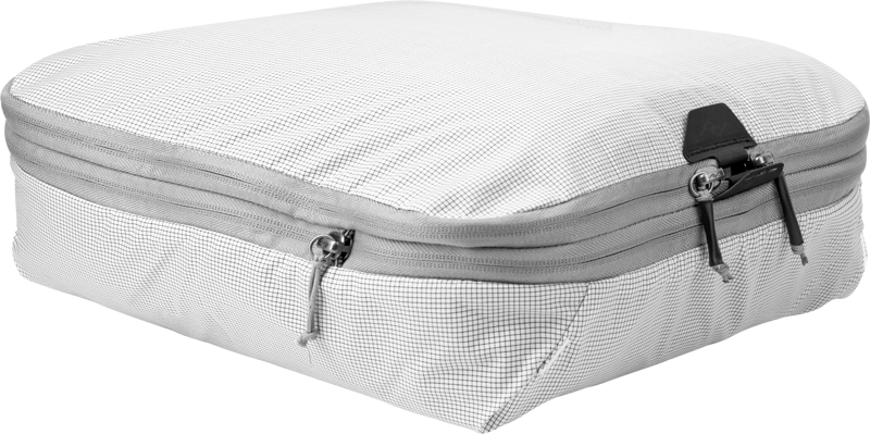 Peak Design Packing Cube // Medium // Raw is a rectangular, white packing cube with a subtle grid pattern, grey zip fastening and two zippers, ideal for organising clothes and luggage.