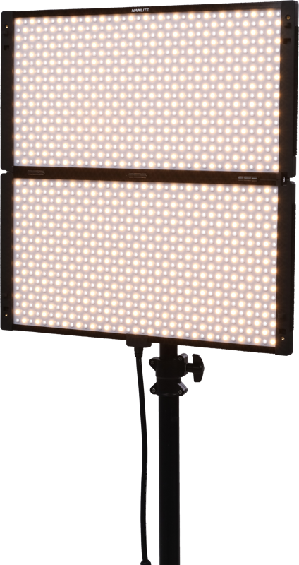 The Nanlite PavoSlim 240B LED panel is a rectangular, two-part LED luminaire with a base, both parts of which emit a warm white light. A power cord hangs from the centre, set against a plain, light background.