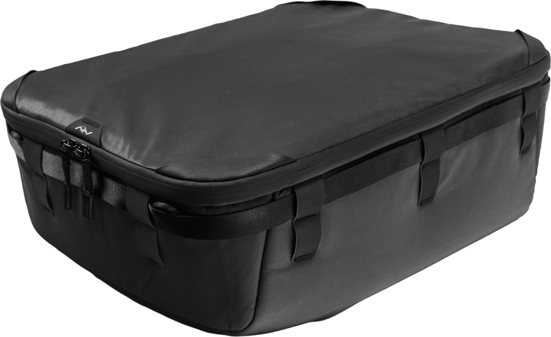 The Peak Design Camera Cube V2 X-Large is a roomy, rectangular black suitcase with a zippered top and multiple side pockets and straps.