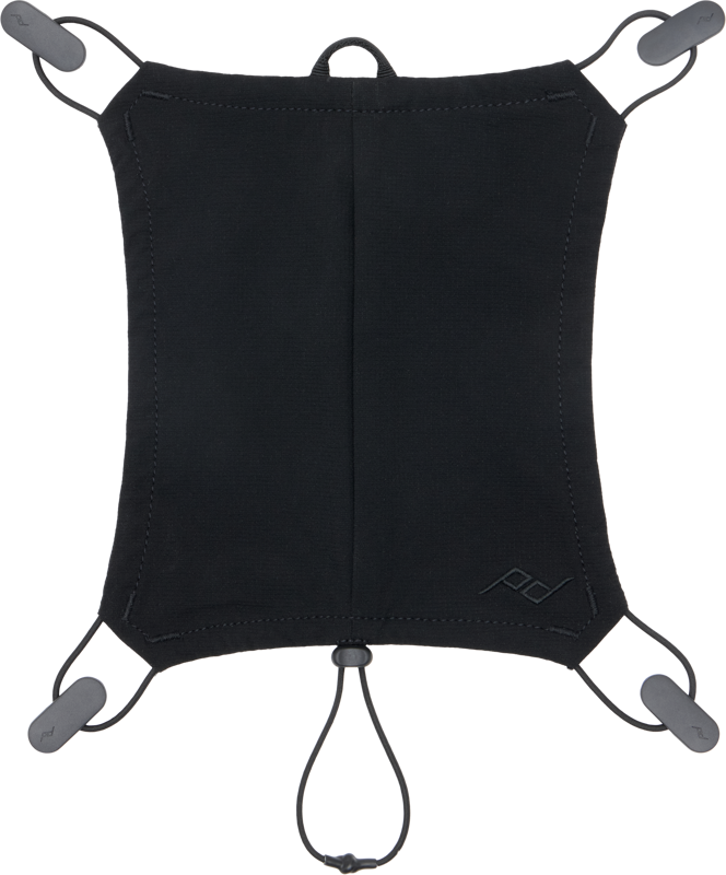 The Peak Design Outdoor Helmet Carry Black is a black rectangular canvas bag with rounded corners, elastic loops at each corner and an adjustable bottom cord ideal for attaching or carrying small items.