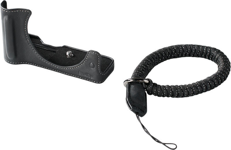 The SmallRig 5433 Leather Half Case Kit for Canon EOS R50 V Black includes a black leather hand grip with white stitching, and next to it is a coiled black camera wrist strap with attachment loop.