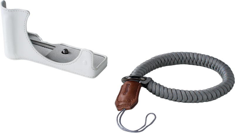 The SmallRig 5431 Leather Half Case Kit for Canon EOS R50 V White and grey braided wrist strap with brown leather accents appear on a light background.