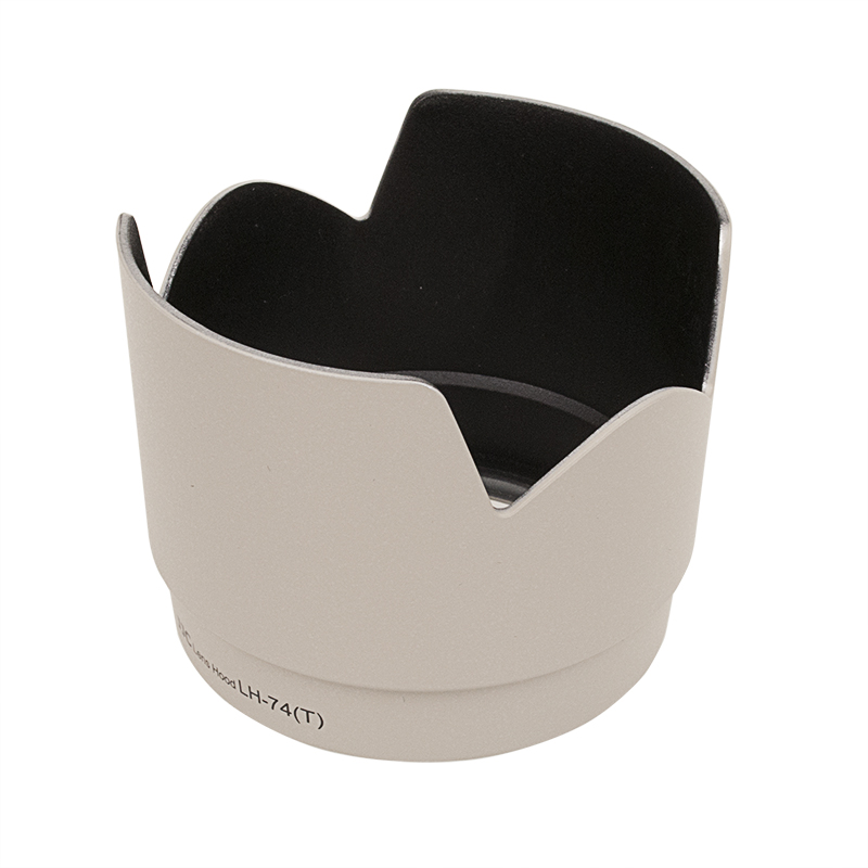 JJC ET 74 Canon Lens Hood White is a light grey, petal-shaped lens hood with a matte black interior that attaches to the front of the camera lens to block stray light and reduce glare.