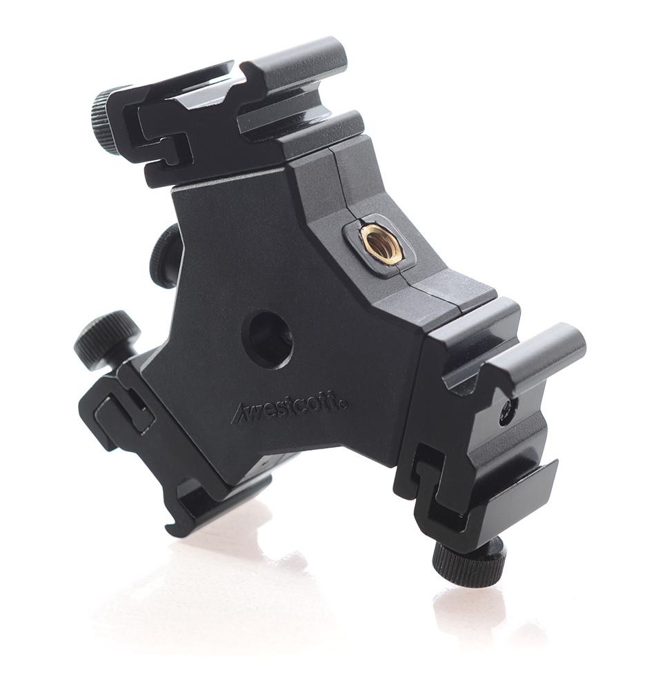 Westcott The Triple Threat, a black metal camera accessory mount with three cold shoe mounts, adjustment knobs and a central brass threaded insert, shown on a white background with subtle reflection.