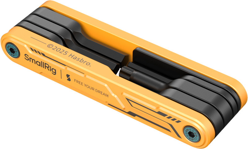 SmallRig 5517 Foldable Multi-Tool Kit - BumbleBee Edition is a small orange and black tool with the words "SmallRig" and "FREE YOUR DREAM" on the side and the © 2025 Hasbro logo, pictured on a lightweight surface.