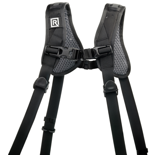 The BlackRapid Double Slim Breathe Camera Strap is a black camera harness with padded shoulder straps, adjustable buckles, a comfortable mesh bottom, a square logo on one strap and even weight distribution over the shoulders.