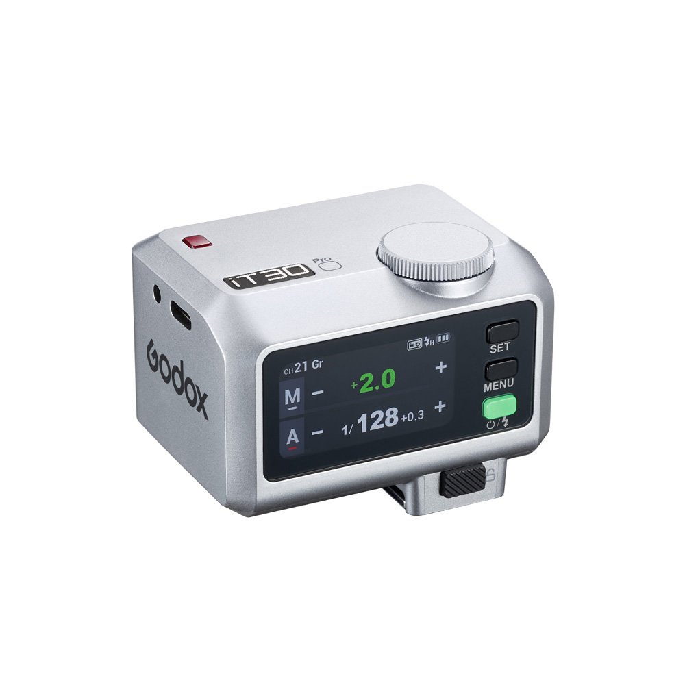 The Godox iT30Pro N Silver iFlash TTL camera flash is a compact silver-coloured flash controller with an LED display for settings, control buttons, a large dial and the Godox logo on the side.