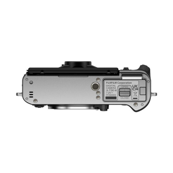 Fujifilm X-T30 III Body Silver top-down silver digital camera image showing the battery compartment, labels and part of the lens.