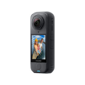 X4Air2 The black Insta360 X4 Air Standard Bundle action camera with touchscreen shows a smiling man and woman in outdoor clothing standing on a wooden pier by the water under a blue sky.