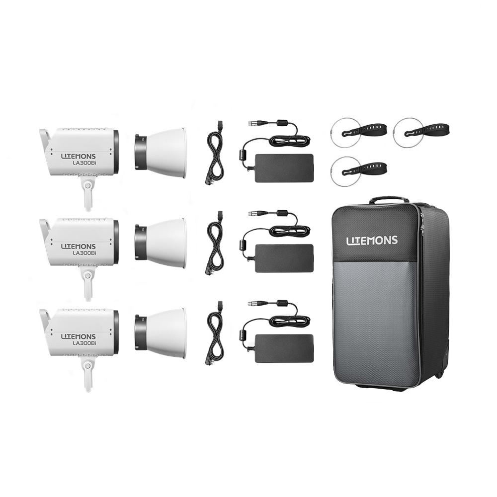Godox Litemons LA300Bi Bi-Color LED Video Light 3 Light Kit Valkoinen sisältää kolme LED-valoa, kolme virtalähdettä, kolme kaapelia, pyöreät kiinnikkeet ja suuren mustan kantolaukun, jonka etupuolella lukee "LITEMONS".