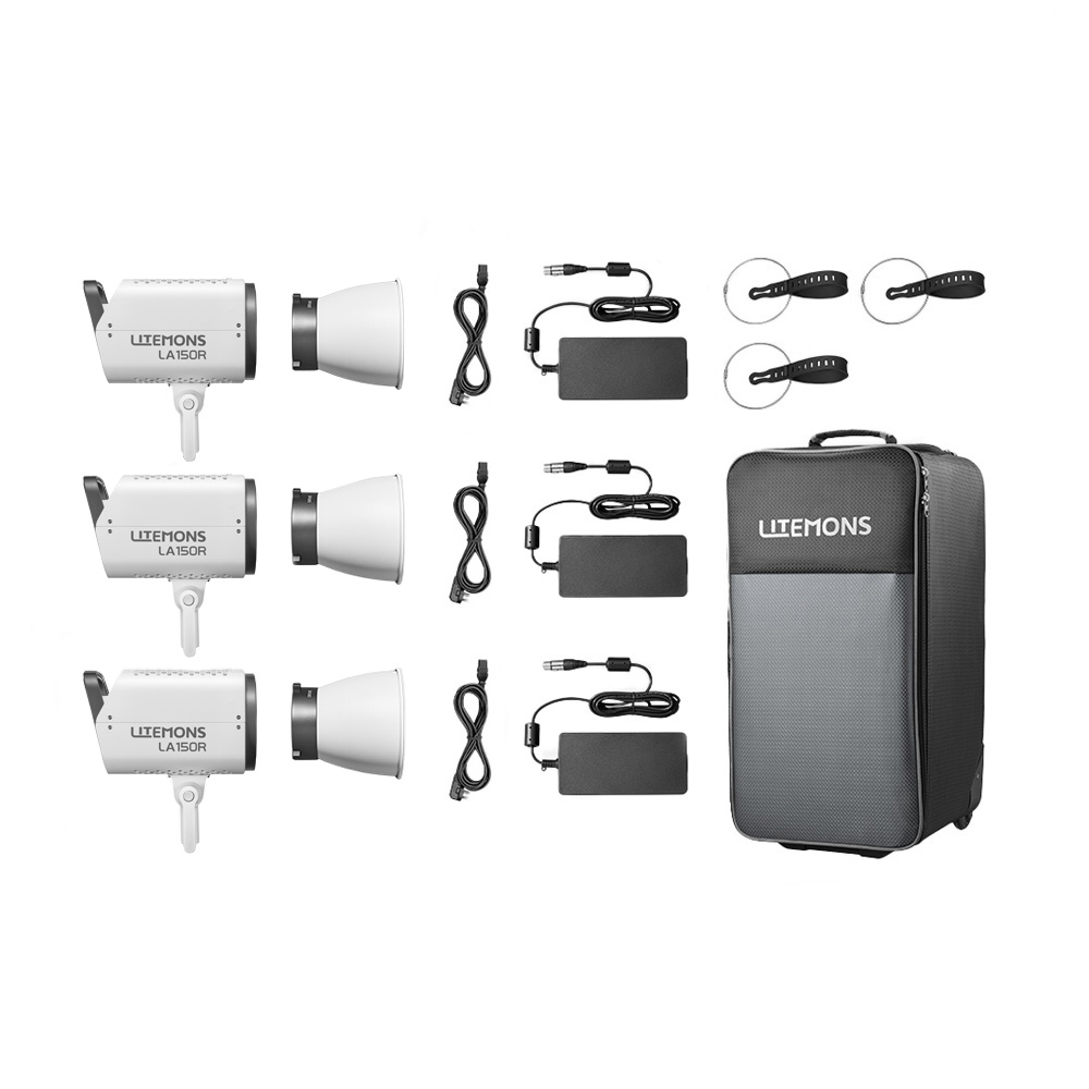 Kolme Godox Litemons LA150R RGB LED Video Light 3 Light Kit Valkoinen -yksikköä virtajohtoineen, sovittimineen, kaukosäätimineen ja suurine pyörillä varustettuine kantolaukkuineen on sijoitettu valkoiselle taustalle.