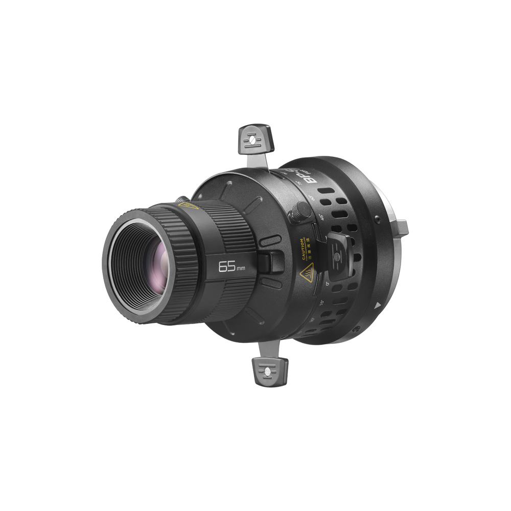 Godox Litemons LED Projection Attachment 65mm:n mustassa rungossa on keltaiset merkinnät, kaksi sivukiinnikettä ja metallinen takakiinnike, kuvassa valkoista taustaa vasten.