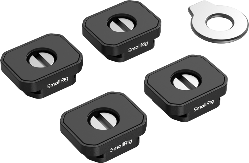 Four black rectangular SmallRig 5472 Mount Plate with Cold Shoe Mount plates, arranged together and with holes in the middle, are displayed next to a silver coin-shaped tool on a light background.